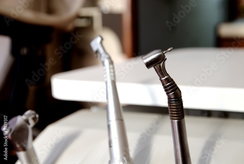Photo: A dentists drill on a table in office room. A dentists drill on a table in office room.