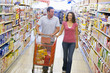 Couple shopping in supermarket aisle