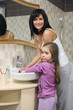 Mother and daughter washing hands