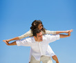Young man giving piggyback to woman