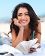 Happy young woman holding book