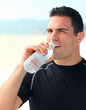Young man drinking bottle of water