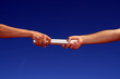 hands passing the batton hands passing the batton