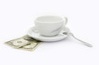 Empty cup of coffee with two dollars tip