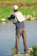 Fisherman angling on the river
