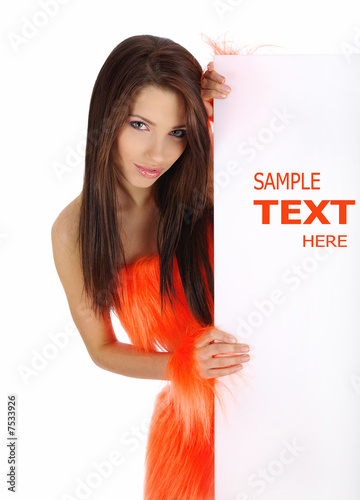 Photo: smiling girl in orange costume holding a blank billboard. smiling girl in orange costume holding a blank billboard.