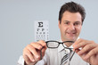 Optometrist holding eyeglasses frames for customer