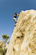 Man Climbing on Cliff