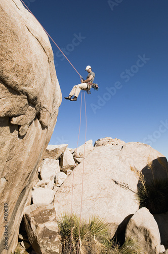 Photo: Man Rappelling on Cliff Man Rappelling on Cliff
