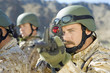 Soldier aiming rifle, outdoors, close-up