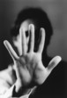 Man holding up hand, close-up of palm of hand, b&w
