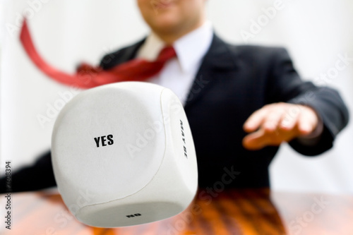 Photo: Businessman throwing a dice Businessman throwing a dice
