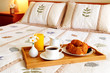 Breakfast on a bed in a hotel room Breakfast on a bed in a hotel room