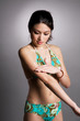 Asian woman applying lotion