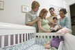 Two couples and baby 1-6 months by cradle