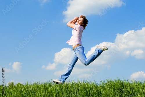 Foto: happy young woman is jumping happy young woman is jumping