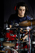 Portrait of young musician playing the drums