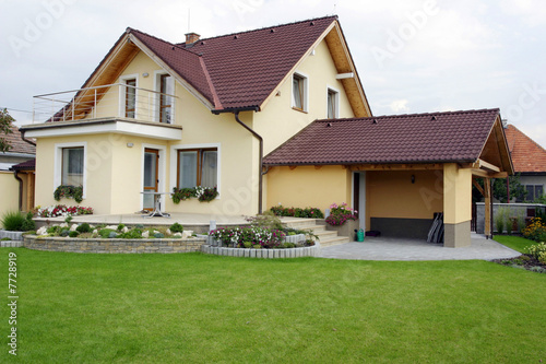 Yellow hous and summer garden.