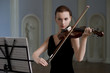 The beauty brunette plays the violin in concert hall The beauty brunette plays the violin in concert hall