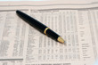 an expensive pen on a newspaper