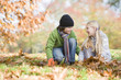 Photo: Two children collecting leaves Two children collecting leaves