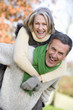 Photo: Senior man giving woman piggyback ride Senior man giving woman piggyback ride