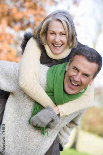 Senior man giving woman piggyback ride