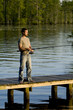 Man fishing on a dock Man fishing on a dock