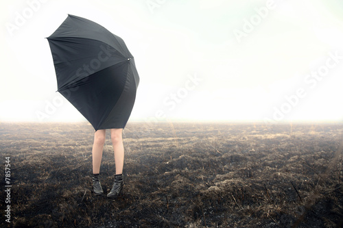 Photo: girl with umbrella on black field girl with umbrella on black field