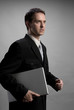 Man holding laptop, walking