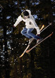 Skier in the Air with White Coat and Blue Pants Skier in the Air with White Coat and Blue Pants