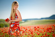 Laughing woman in poppy field