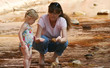 A Woman and Toddler Wade in a Creek