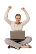 Young woman with laptop, looking in the camera, raising her arms