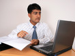Young Indian business man working at his desk (Series)