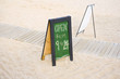 Beach bar board with opening hours