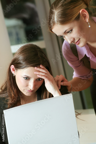 Photo: young frustrated business woman consoling by her colleague young frustrated business woman consoling by her colleague