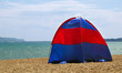 tent pitched on a stony beach