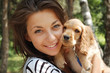 Girl holds her little dog, so cute that it looks like a toy.