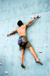 The climber trains on an artificial rock