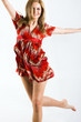 young beautiful jumping woman wearing a red dress