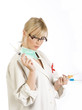 Female blond Nurse with syringes isolated on white background