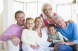 Family sitting indoors smiling