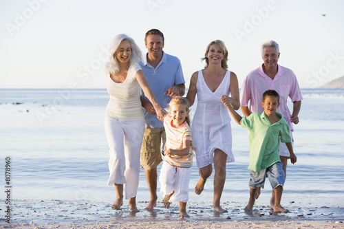Photo: Extended family walking on beach Extended family walking on beach