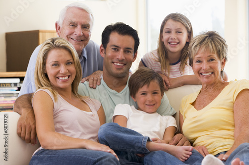 Photo: Extended family in living room smiling Extended family in living room smiling