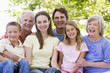 Extended family outdoors smiling