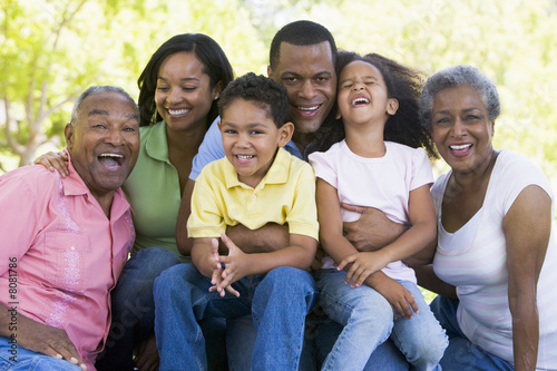 Photo: Extended family sitting outdoors smiling Extended family sitting outdoors smiling