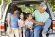 Grandparents with grandkids in tailgate of car