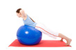 Young woman performing fitness exercises with a fitness ball. Young woman performing fitness exercises with a fitness ball.