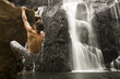 Rock climber at waterfall